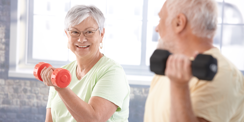 Older couple lifting weights